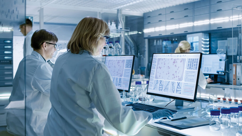 Female and Male Scientists Working on their Computers