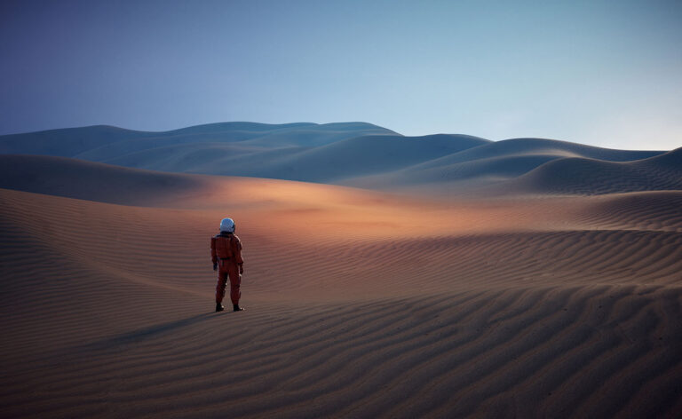 Astronaut in the desert looking at the moon