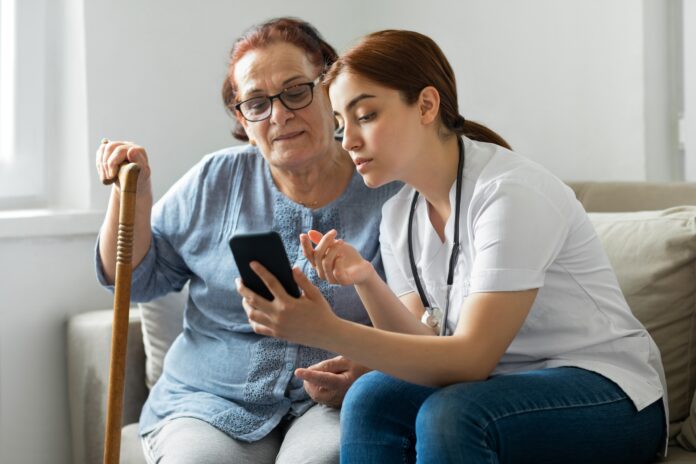 Senior woman with nurse at home